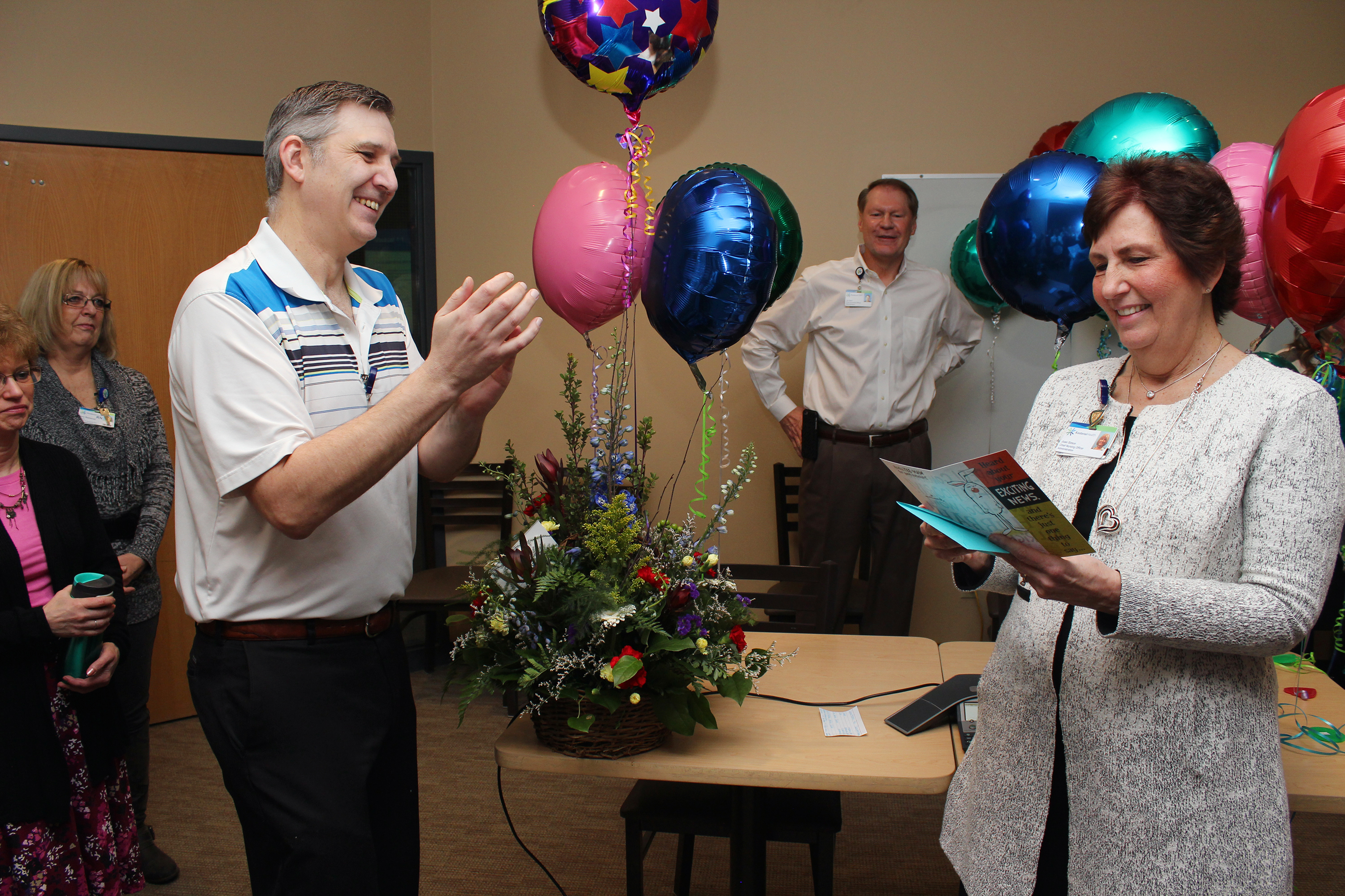 Kootenai Health nurses, administration and other staff celebrate Thursday morning after being notified that Kootenai was re-designated as a Magnet hospital by the American Nurses Credentialing Center. From left: Robert Mendenhall, Magnet documentation and communications coordinator, and Joan Simon, Kootenai Health Chief Nursing Officer