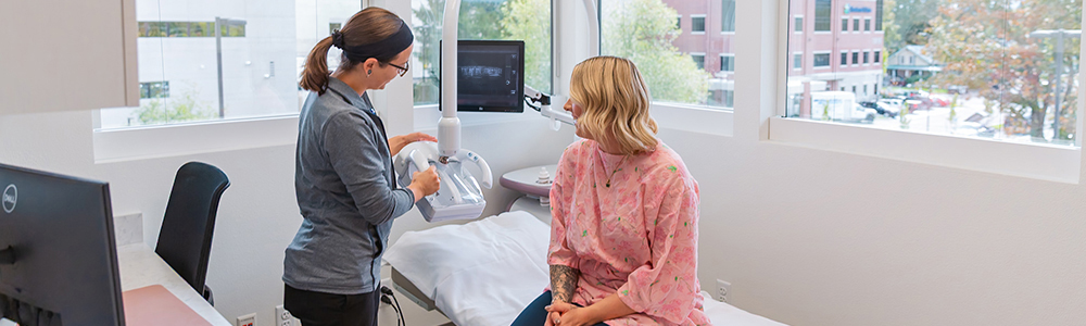 Woman receiving mammogram in corner suite